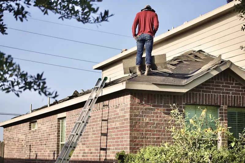 Professional roofer working on a residential roof in Ameritrail